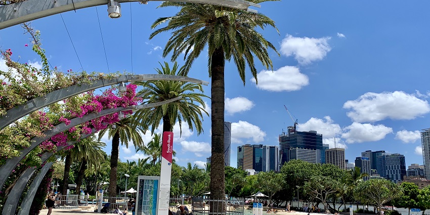 Vibrant area with gardens, restaurants, and cultural events