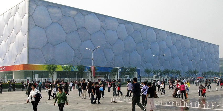 Image of Beijing National Aquatics Centre from the outside and visitors strolling around