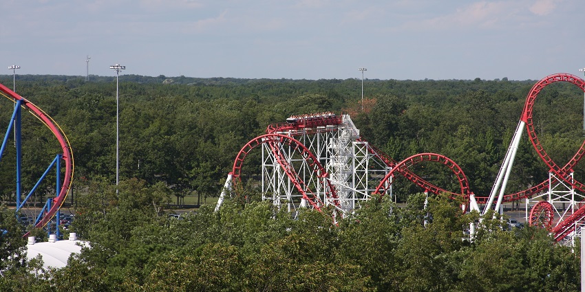Six Flags great adventure amusement park with a roller coaster ride track in greenery
