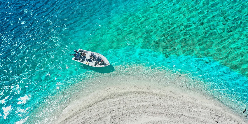 A beautiful beachside that has natural beauty and no crowd contains tranquility.
