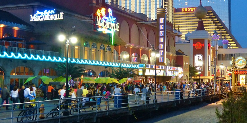 Atlantic City boardwalk in the evening with people walking and bicycles parked near stores