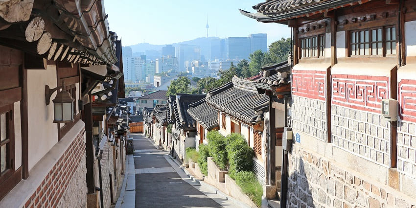 Bukchon Hanok Village showcases traditional Korean houses amidst scenic, historic surroundings