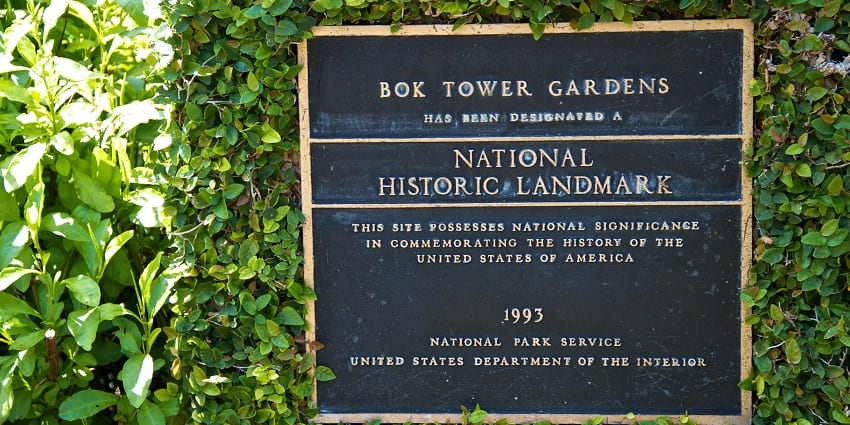 A board showing the National Historic Landmark status of the Bok Tower Gardens in Florida.