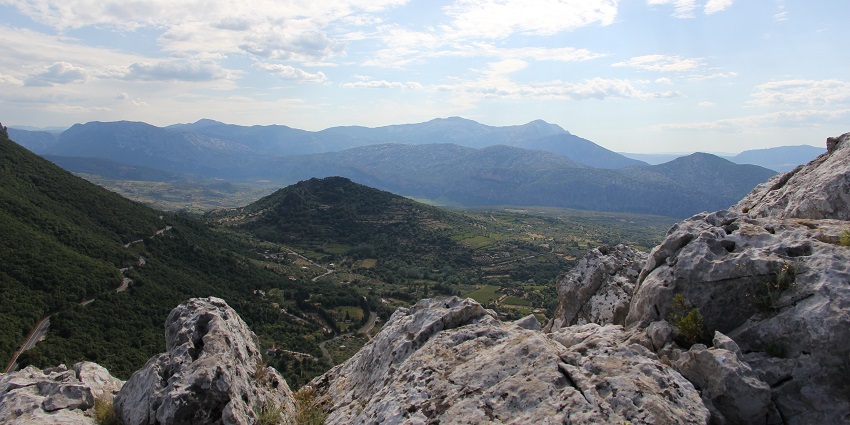 Mountainous region offering caves, and scenic views, showcased in Sardinia travel guide.