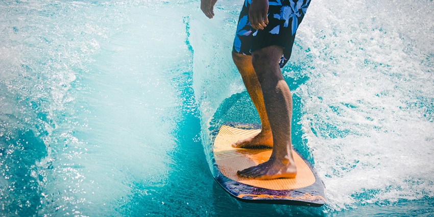 Surfing through the waters of South Shore is one of the top things to do in Hawaii in May.