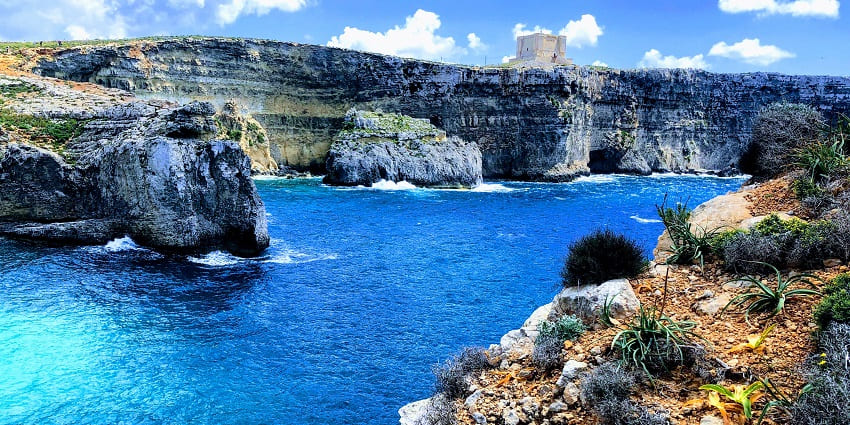 Crystal clear turquoise waters of Blue Lagoon one of the things to do in Malta in October.