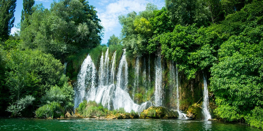 An image of the serene waterfall in designated areas for the park activities.
