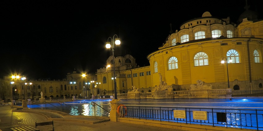 An image of couples relaxing in the warm thermal pools of Széchenyi Bath.