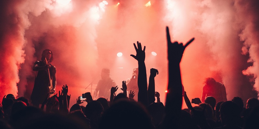 An image showing a lively audience enjoying a music performance in a vibrant setting.