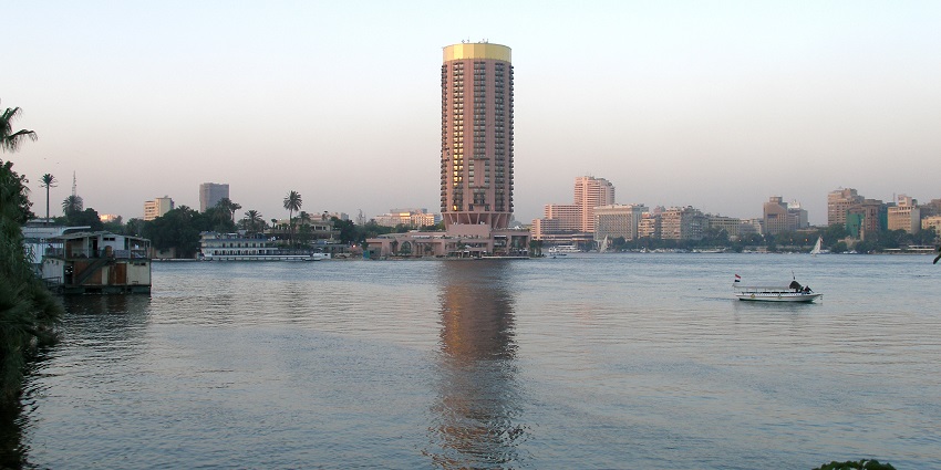 The Nile, a prime cruise destination, flows beside the tall skyscrapers, one of the best things to do in Cairo in December.