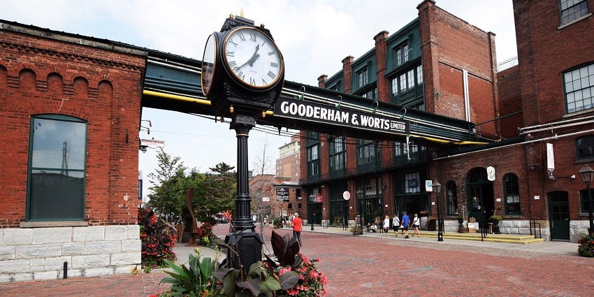 Outside view of Distillery District with signboard of Gooderham and WortsLimited and a large clock standing