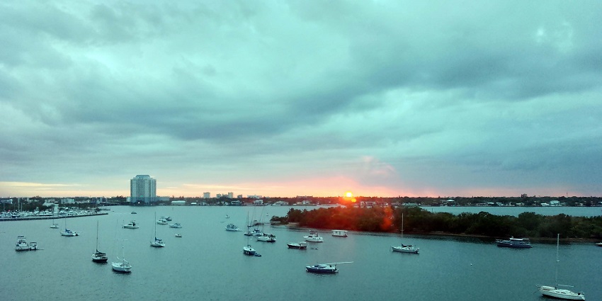 Several boats sail as sunsets in the background in Biscayne Bay, Miami, Florida, USA