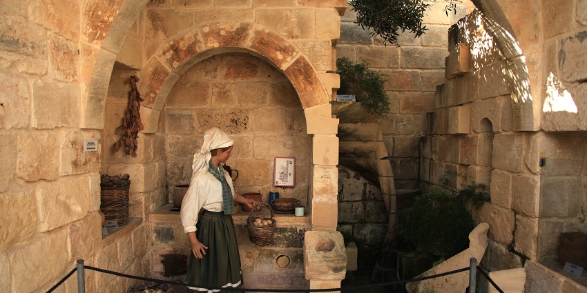 Museum area of Limestone Heritage Park showing a lady dressed in vintage clothes.