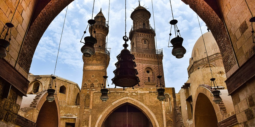 A wide-angle view of the Sultan Hassan Mosque and Al-Rifa'i Mosque in Islamic Cairo.