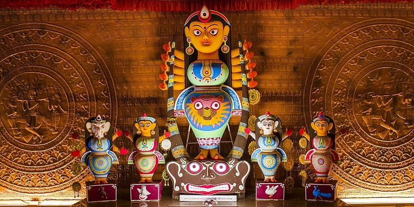 A picture of a tourist photographing exhibits inside Durga Museum Kolkata.