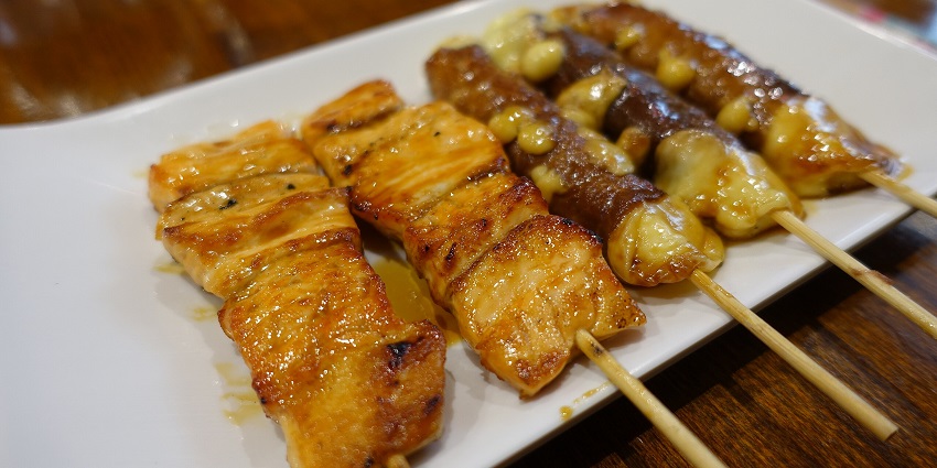 Yakitori skewers feature grilled chicken, seasoned with savory sauces and spices