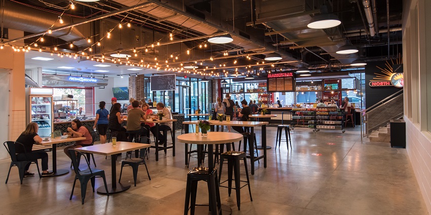Interior of the North Market Bridge Park with a decorated food court and people eating