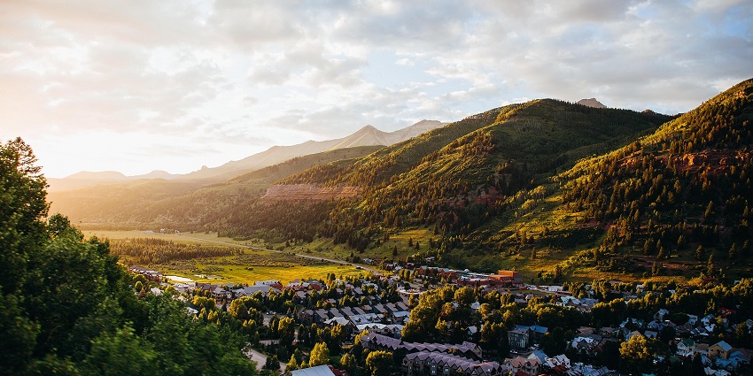 The panorama view of the town of Telluride, surrounded by verdant fields