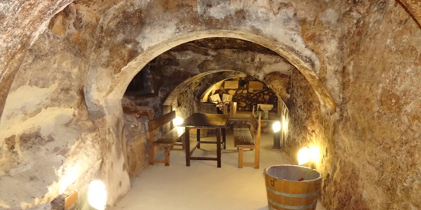 An underground beer cafe with cosy yellow lamps, small chairs tables, and a bucket
Viewers of this file can see comments and suggestions
