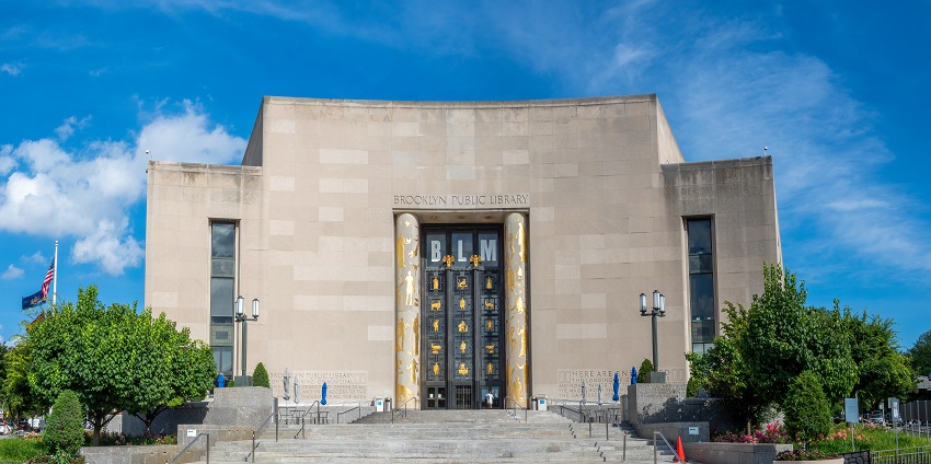 Exterior view of the Brooklyn Public Library with grand architecture and steps.