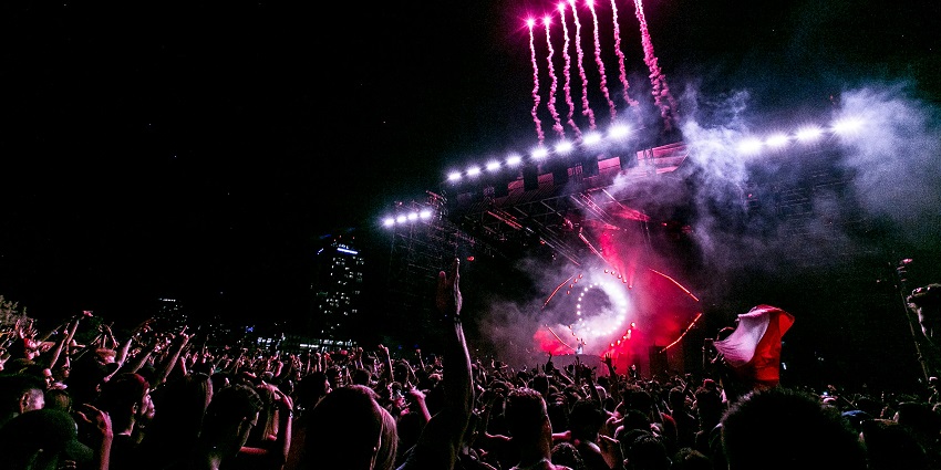 Image of a group of people enjoying at the party and colourful lights around