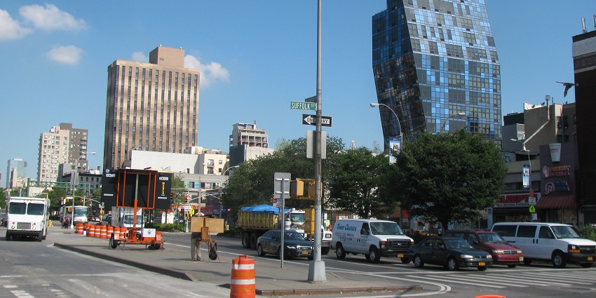A view of Delancey Street in New York with cars, the best places to celebrate New Year in New York.