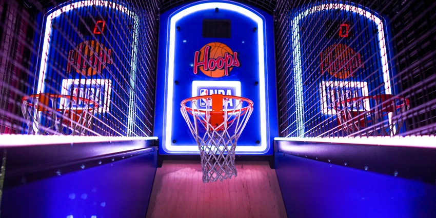 Image of a gaming arcade basketball with vibrant lights available for adults and children