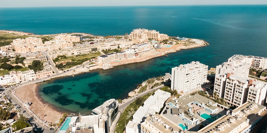 An architectural building on the island of Gozo is looking amusing with the sea behind.