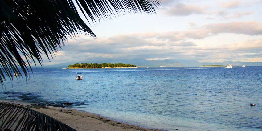 A distant view of several small islands situated near each other surrounded by ocean