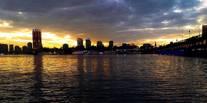 The Nile River of Egypt, surrounded by tall, lit buildings, suitable to celebrate Valentine’s Day in Egypt.