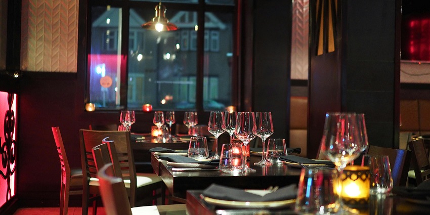 An image of wine glasses on a table, perfect for celebrating Valentine's Day Events in Atlanta.