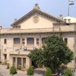 An image of the High Court in Allahabad (Prayagraj) which shows a historic structure with a lawn in the front.