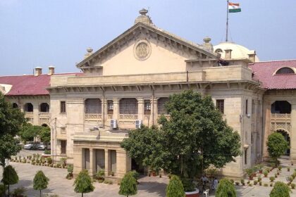 An image of the High Court in Allahabad (Prayagraj) which shows a historic structure with a lawn in the front.