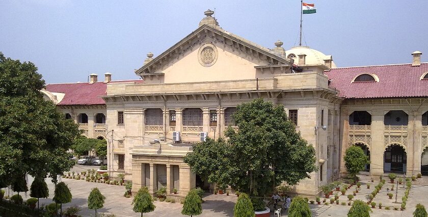 An image of the High Court in Allahabad (Prayagraj) which shows a historic structure with a lawn in the front.