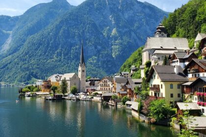 A picture ofHallstatt, Austria, with colourful buildings along the Inn River and Alps