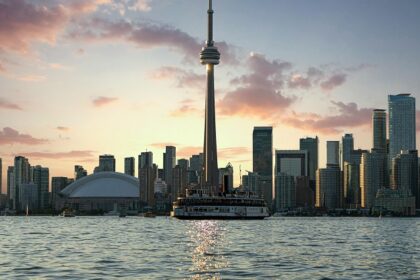 Toronto in the morning with the Tall CN tower, tall skyscrapers and Lake Ontario