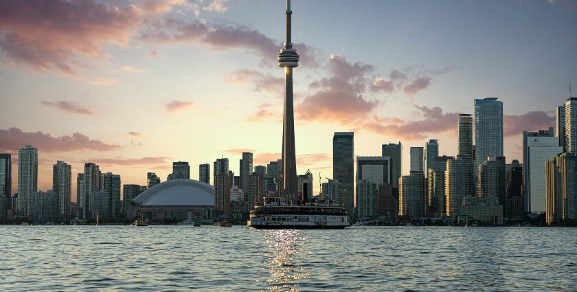 Toronto in the morning with the Tall CN tower, tall skyscrapers and Lake Ontario