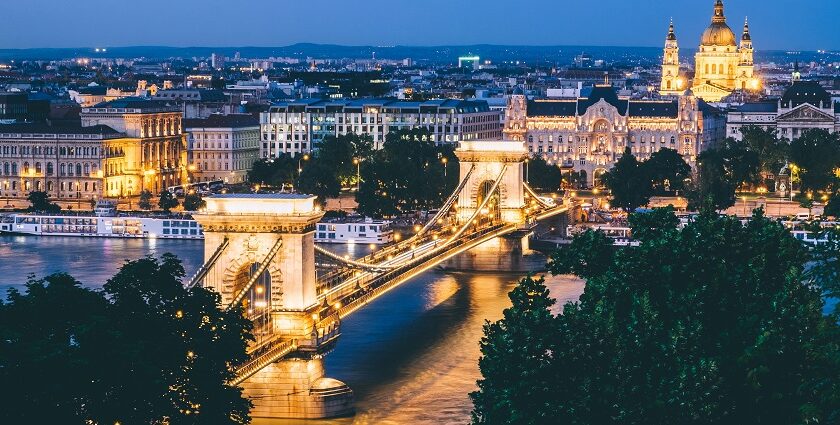 A view of Budapest's Chain Bridge, with the light reflecting through the Danube River.