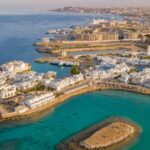 An aerial view of Hurghada adjacent to the Red Sea, featuring white buildings all over.