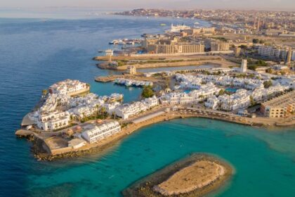 An aerial view of Hurghada adjacent to the Red Sea, featuring white buildings all over.