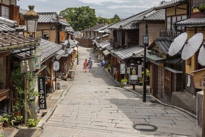 Ninenzaka, a pedestrian paved street with paper umbrellas on a storefront that showcases Japan's architecture