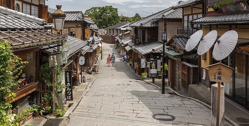 Ninenzaka, a pedestrian paved street with paper umbrellas on a storefront that showcases Japan's architecture