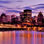 Skyline of Montreal with vibrant, colourful lit-up buildings and tall skyscrapers