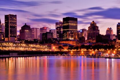 Skyline of Montreal with vibrant, colourful lit-up buildings and tall skyscrapers