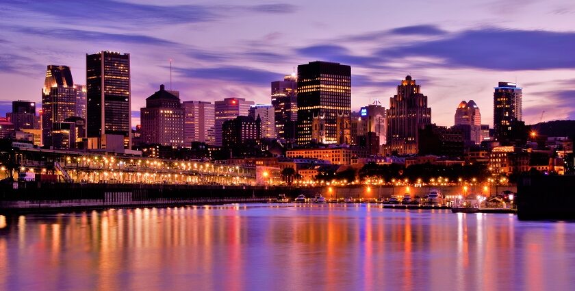 Skyline of Montreal with vibrant, colourful lit-up buildings and tall skyscrapers