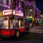 Vibrant street in Old town Orlando at night with a small food on wheels named turkey legs