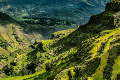 A lush green mountain range and a valley in between is looking divine in soft daylight.