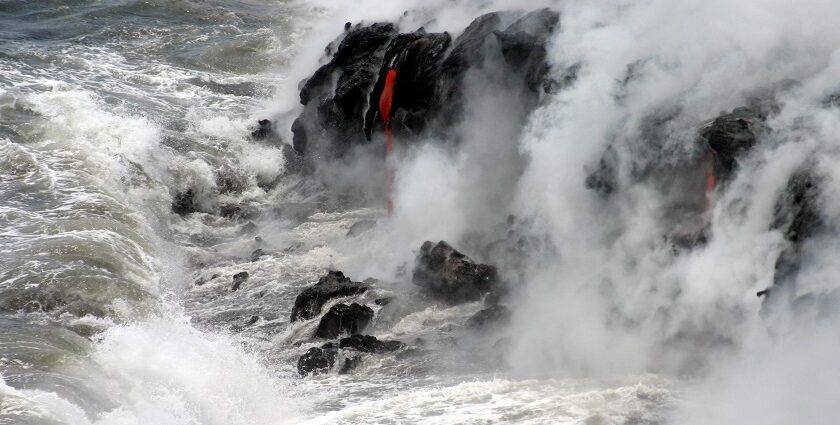 A spectacular moment when hot lava meets the ocean, forming new rocks in Hawaii.