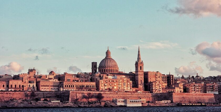 Periodic buildings with typical architecture are standing tall near a vast waterbody.