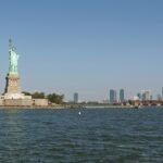 Liberty Island with the Statue of Liberty and downtown Jersey City, one of the best things to do in New Jersey.